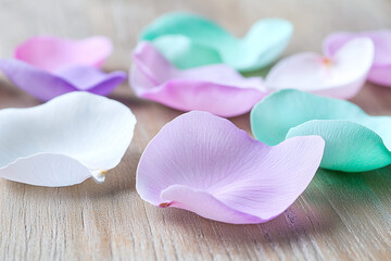 soft pastel-colored petals scattered across a wooden surface.