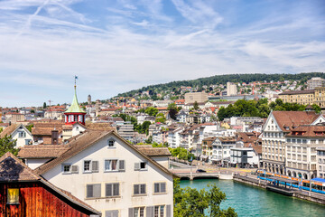 Obraz premium Zurich, Switzerland - July 26, 2024: The waterfront and old town at the mouth of the Limmat Riverl in Zurich Switzerland 