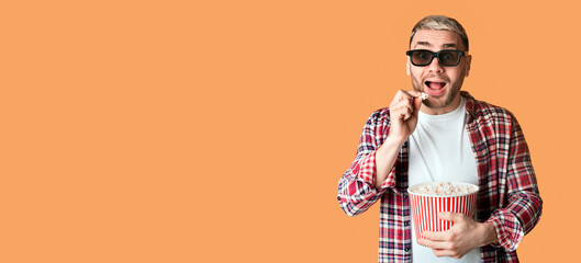 Man at cinema fun. Young male eats popcorn, free space