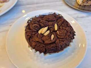 Classic baked brownie cup cake serving on the plate. Famous sweet bakery menu in restaurant.