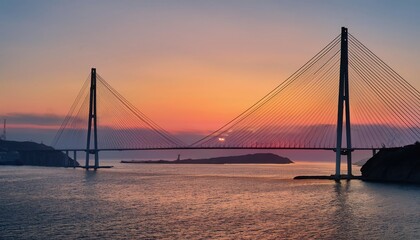 A stunning sunset view of a cable-stayed bridge spanning calm waters, complemented by a colorful sky reflecting the day's end.