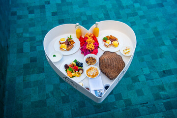 Floating breakfast in a heart shape in the pool in Maldives