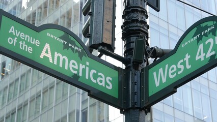 New York City crossroad, 42 street intersection green road sign. 6 Sixth ave, Americas avenue corner, Midtown business district, NYC, Bryant park. Highrise skyscraper architecture, text roadsign.