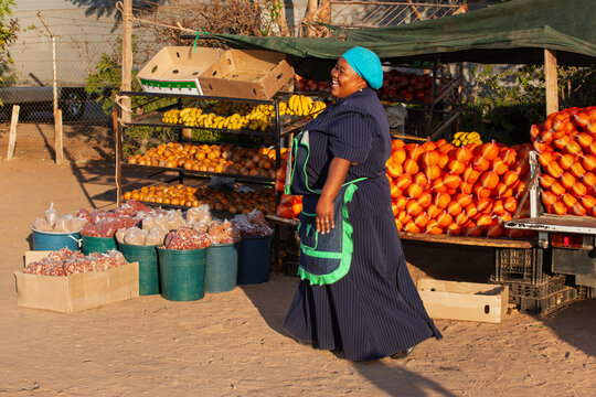 woman african street vendor selling oranges, small business entrepreneur