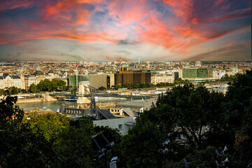 Sunset view of Budapest, highlighting the historic Parliament, Danube River, and iconic landmarks like Buda Castle and Chain Bridge. Perfect for showcasing Hungary’s stunning architecture and vibrant