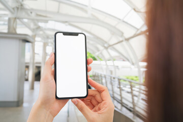 Hand holding smartphone mockup of blank screen, Take your screen to put on advertising.