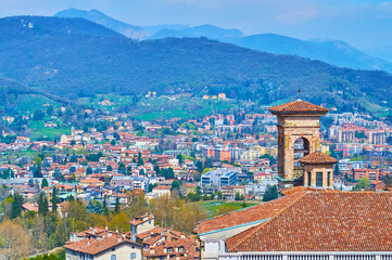 Fototapeta premium The bell tower of San Michele all'Arco church against the Alps, Bergamo, Italy