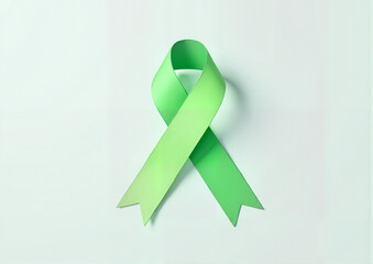 Green mental health awareness ribbon on light background