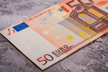 A Detailed CloseUp Image of a 50 Euro Banknote Resting on a Textured Surface with Interesting Features