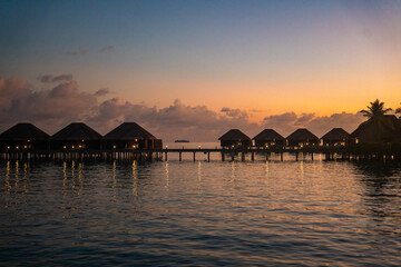 Obraz premium Sunset views from overwater pool villa in Maldives