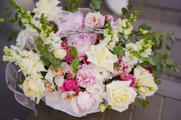 A delicate and beautiful bouquet of roses, peonies and orchids.