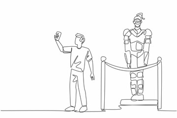 Museum Selfie Day. One single line drawing of young man museum visitor taking selfie with original medieval guard in steel knight armor by smartphone camera at historic exhibition hall