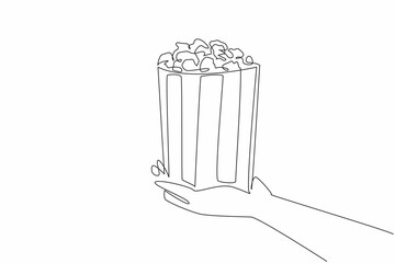 National Popcorn Day. One continuous line drawing of person hand holding stripped paper bucket contain salted popcorn. Food snack to watch a movie concept. Single line draw vector graphic illustration