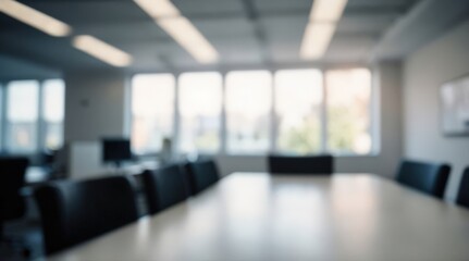 Fototapeta premium Blurred office interior meeting room with desks, chairs and monitors. Blurry working space with softly defocused effect. For background or backdrop use in business concept