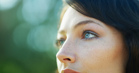 Nature, thinking and face of woman in park for relaxing, remember and reflection outdoors. Garden, closeup and eyes of person in backyard for calm, peace and fresh air with thoughtful expression