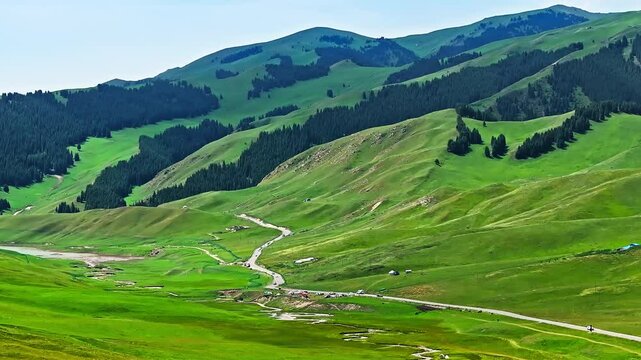 Green grassland with mountain natural landscape in summer. Yizhao Highway is one of the most beautiful highways in Xinjiang, China.