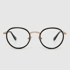 Fototapeta premium Round glasses with golden trim on a white isolated background.