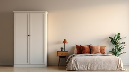 A cozy bedroom featuring a simple bed, decorative pillows, a bedside table with a lamp, a wardrobe, and a potted plant against a light wall.