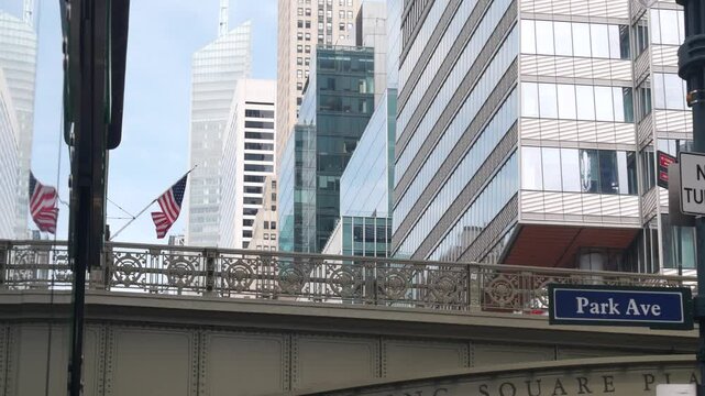 New York City Grand Central Terminal, 42 street, Park Avenue, Pershing Square bridge architecture. Midtown district railroad hub, railway transport. American flag, NY crossroad, intersection road sign