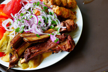 Grilled ribs with marinated onions and grilled vegetables. 