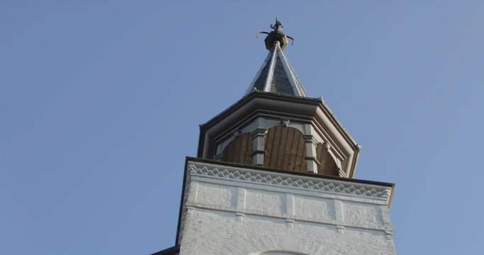 Close low angle pan of a beautiful and historical church tower on a sunny day