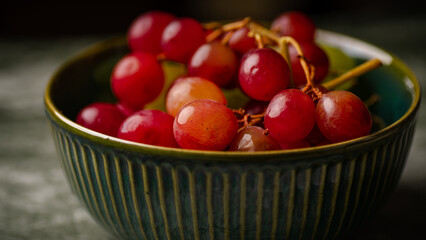 Close-Up of Fresh Green and Red Grapes in a Dark Bowl