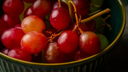 Close-Up of Fresh Green and Red Grapes in a Dark Bowl