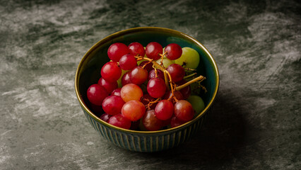 Close-Up of Fresh Green and Red Grapes in a Dark Bowl