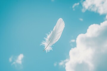 A single white dove feather floating peacefully in the sky with soft clouds