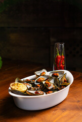 boiled asian green mussel perna viridis served in white plate with chili