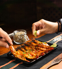 hand squeezed lime onto grilled shrimp served with garnish