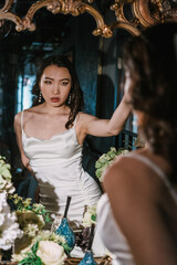 Elegant Woman in Beautiful Vintage Setting Thoughtfully Reflecting in the Mirror