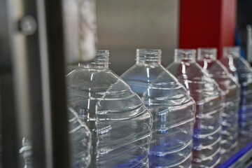 Plastic bottles on a conveyor belt at the factory.