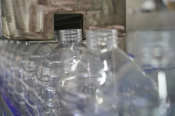 Plastic bottles on a conveyor belt at the factory.
