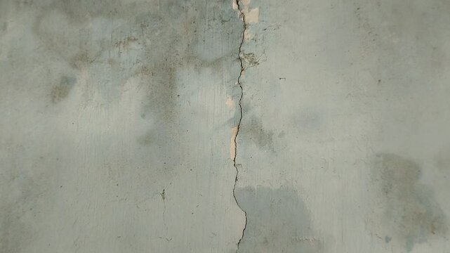 the house wall is cracked. The crack was caused by extreme weather