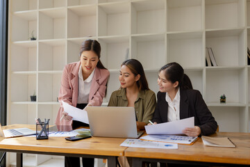 Asian businesswoman teamwork working on laptop with finances analysis report at desk in office, business financing, accounting banking, Team of creative and business planning, 