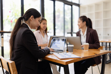 Asian businesswoman teamwork working on laptop with finances analysis report at desk in office, business financing, accounting banking, Team of creative and business planning, 