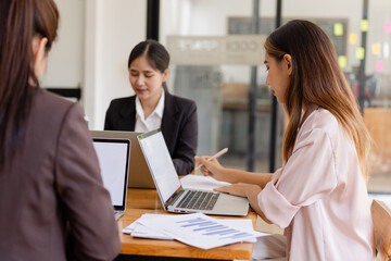 Asian businesswoman teamwork working on laptop with finances analysis report at desk in office, business financing, accounting banking, Team of creative and business planning, 