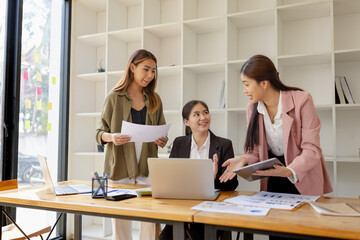 Asian businesswoman teamwork working on laptop with finances analysis report at desk in office, business financing, accounting banking, Team of creative and business planning, 