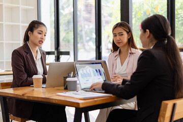 Asian businesswoman teamwork working on laptop with finances analysis report at desk in office, business financing, accounting banking, Team of creative and business planning, 