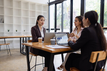 Asian businesswoman teamwork working on laptop with finances analysis report at desk in office, business financing, accounting banking, Team of creative and business planning, 
