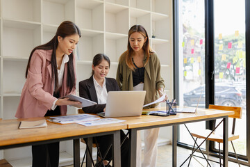Asian businesswoman teamwork working on laptop with finances analysis report at desk in office, business financing, accounting banking, Team of creative and business planning, 