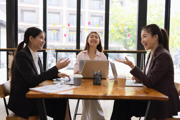 Technology and financial advisory services concept. Businesswoman teamwork and working on digital laptop computer with advisor showing plan of investment to clients at table office. Digital marketing.