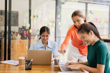 Excited Asian businesswoman team working together in office, About successful startup projects concept.