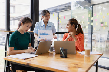 Technology and financial advisory services concept. Businesswoman teamwork and working on digital laptop computer with advisor showing plan of investment to clients at table office. Digital marketing.