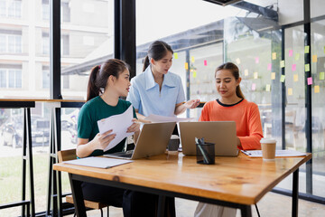 Technology and financial advisory services concept. Businesswoman teamwork and working on digital laptop computer with advisor showing plan of investment to clients at table office. Digital marketing.