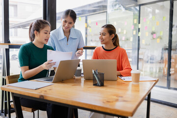 Technology and financial advisory services concept. Businesswoman teamwork and working on digital laptop computer with advisor showing plan of investment to clients at table office. Digital marketing.