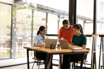 group of asian businesswoman working on laptop with finances analysis report at desk in office, business financing, accounting banking, Team of creative and business planning, 