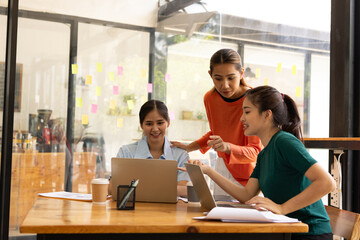 group of asian businesswoman working on laptop with finances analysis report at desk in office, business financing, accounting banking, Team of creative and business planning, 