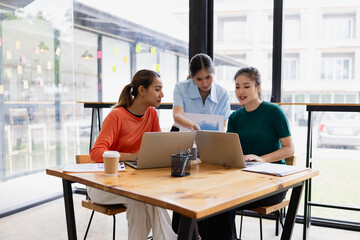group of asian businesswoman working on laptop with finances analysis report at desk in office, business financing, accounting banking, Team of creative and business planning, 